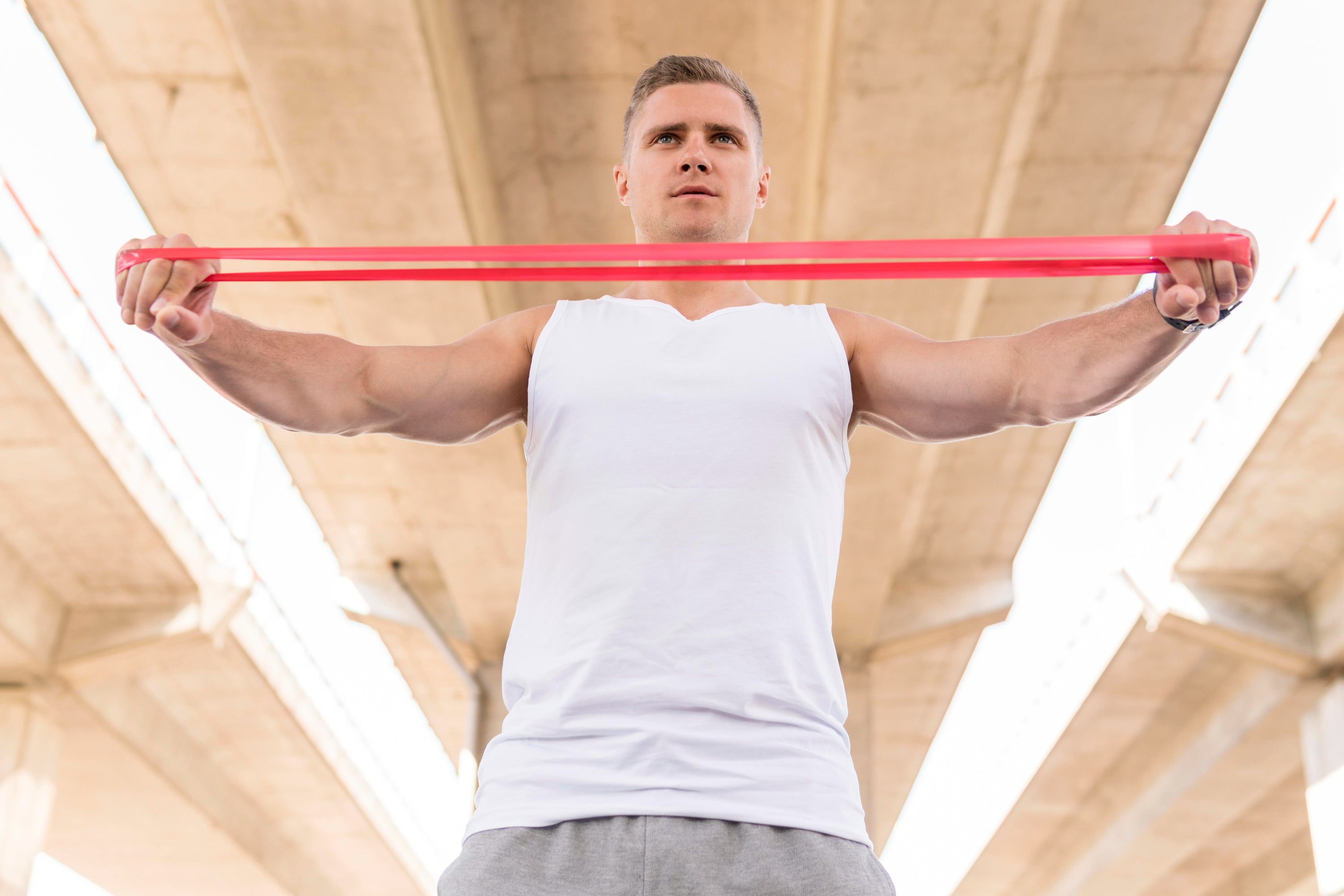 Standing man wearing stringers for bodybuilding